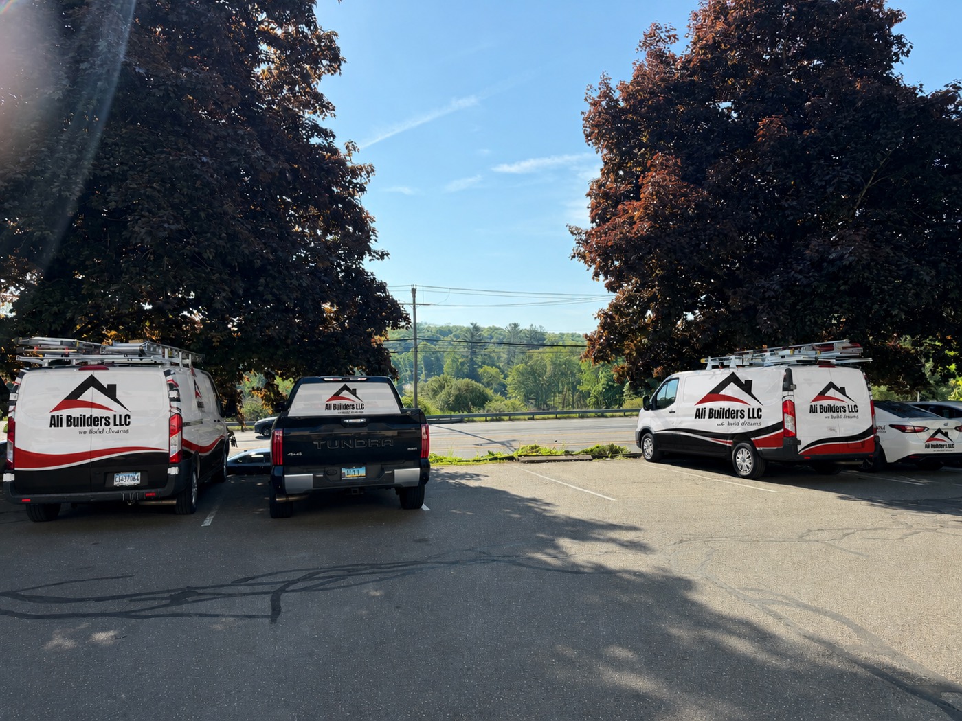 Ali Builders LLC branded fleet of work vehicles